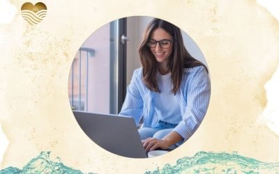 a woman smiling at her laptop